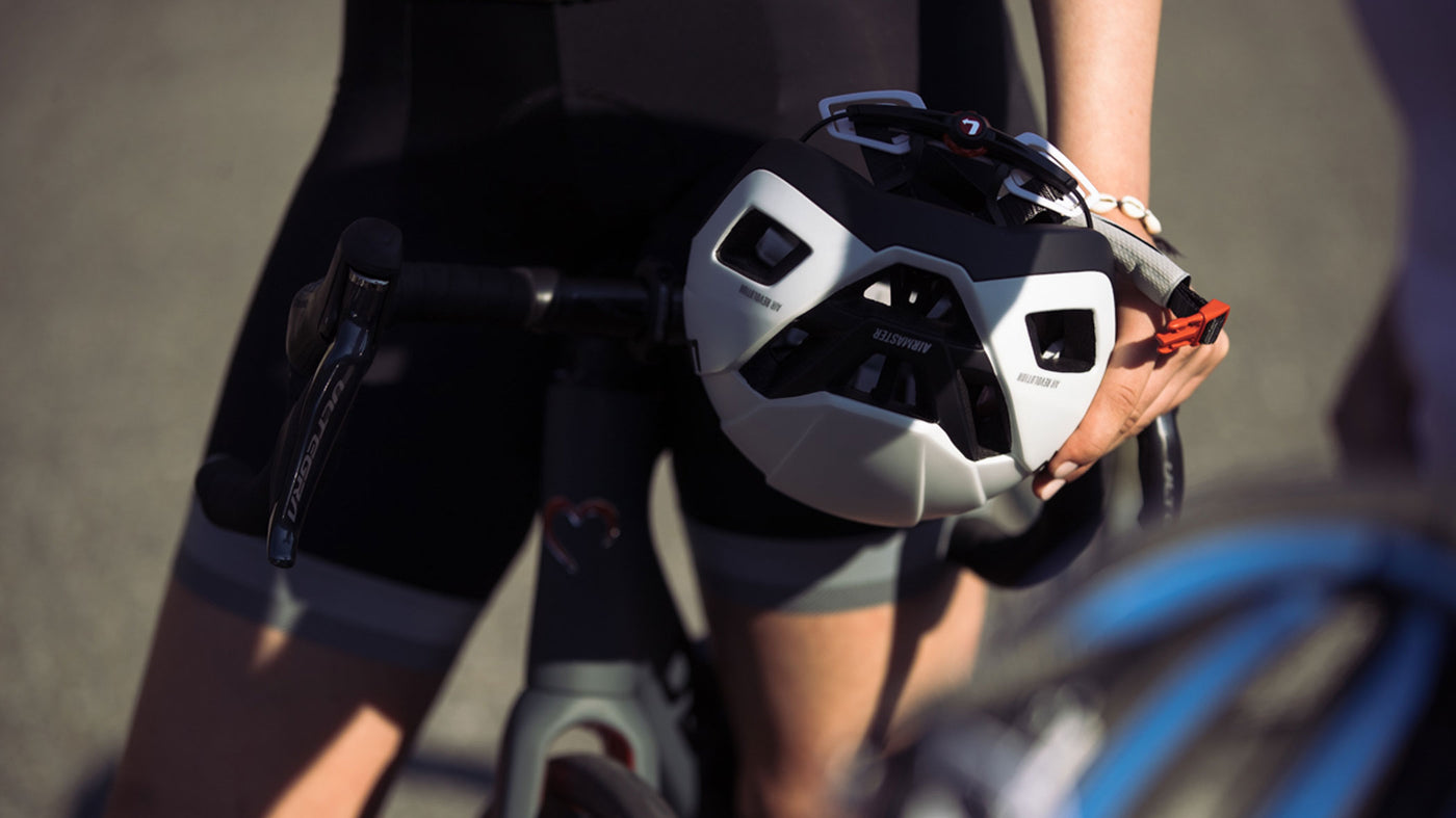 Cyclist holding Limar Air Master bike helmet